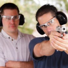 two men shoot gun